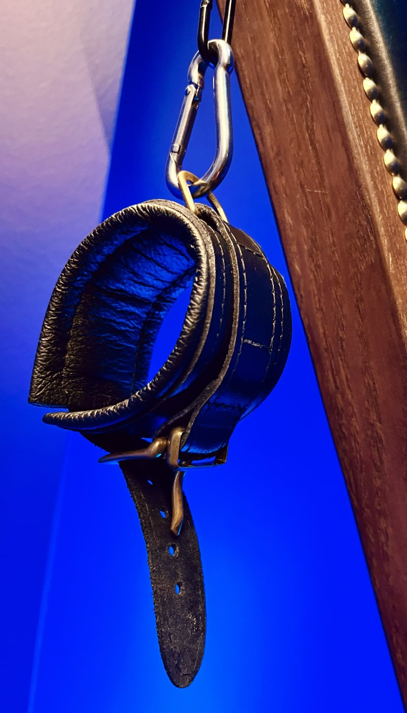 Photo des bracelets de poignets de la croix de Saint André dans la salle de jeu BDSM de la loveroom Le Goût du Péché à Mulhouse